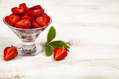 Tahta bir masada olgun çilekler..