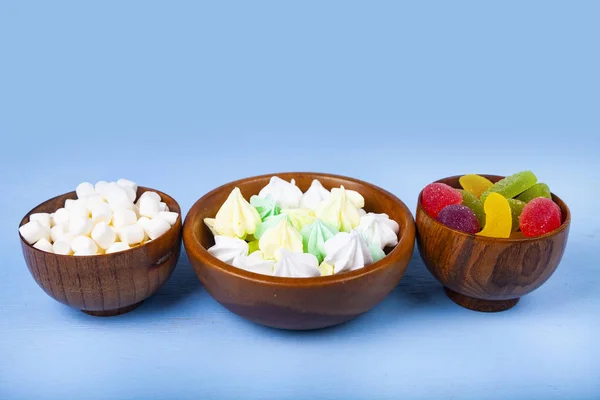 Meringue,marmalade and marshmallow in wooden bowls — Stock Photo, Image