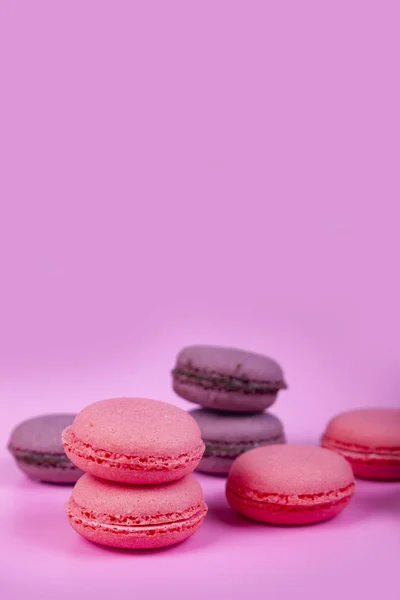 Macaroons on a pink background. Tasty dessert.