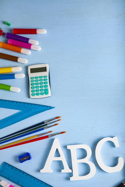 Back to school. Items for the school and letters ABC on a wooden table. Place for your text.