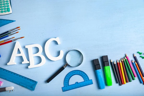 Back to school. Items for the school and letters ABC on a wooden table. Place for your text.