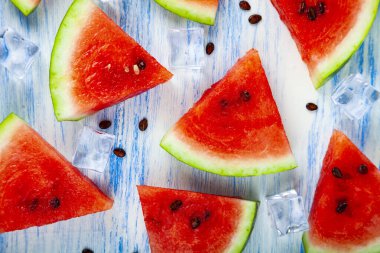 Karpuz ve mavi ahşap bir masa üstten görünüm buza parçalar. Lezzetli tatlı.