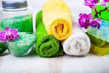 Ahşap arka planda kaplıca aksesuarları ve orkide.