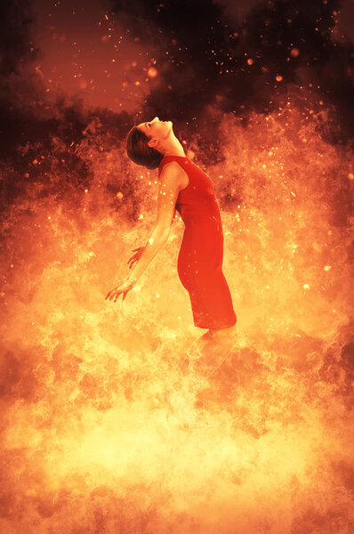 Beautiful woman standing in the midst of a fire
