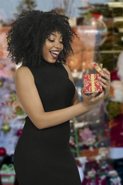 Beautiful woman opening a present — Stock Photo, Image