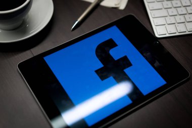 New York, New York / Usa - 11 11 11 2019: Facebook logosu İPad Air2 'de ofis masasında