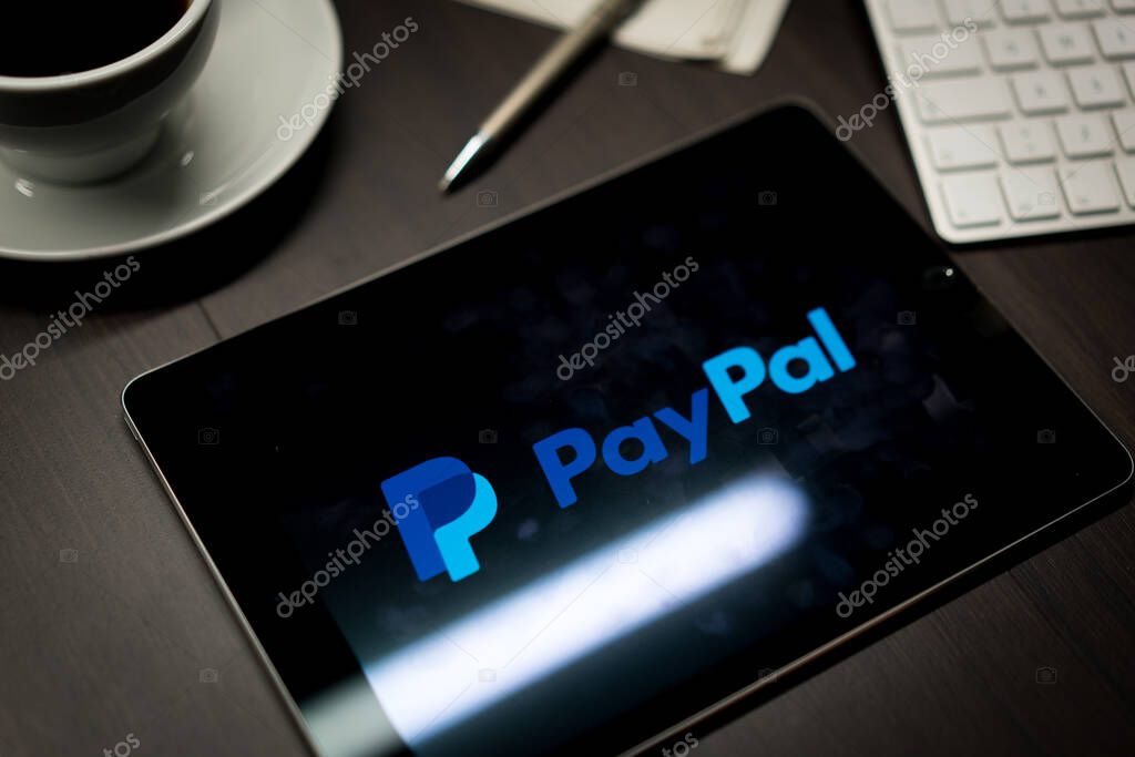 New York, New York / USA - 11 11 2019: Logo of PayPal on the iPad Air2 in on office desk