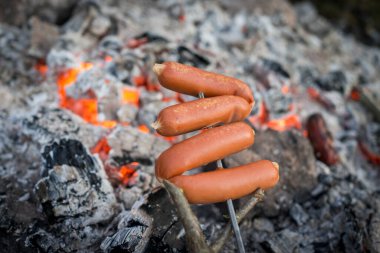 Kamp ateşinde sosis hazırlıyorum.