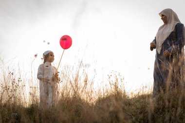 Çimenlerdeki Arap anne ve oğlu