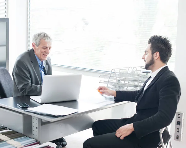 Business people and executives having meeting using laptop