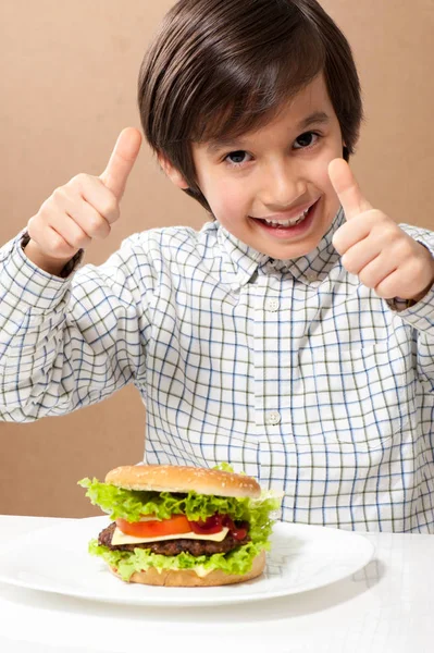 ハンバーガーを食べる子が閉じます — ストック写真