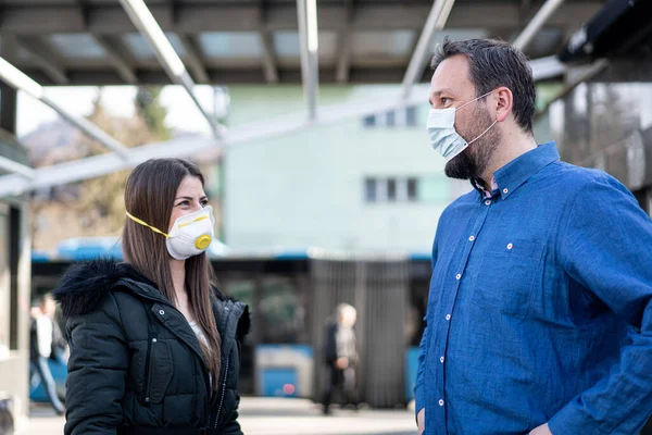 Couple on street with mask against virus pollution