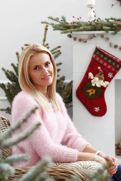 woman sitting by fireplace