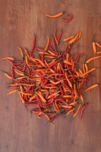 composition of red chili peppers on wooden table