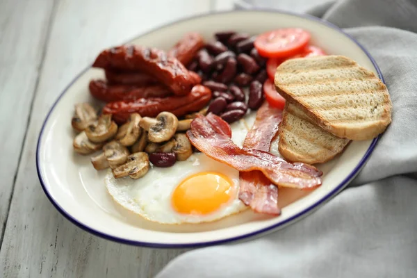 Food and cuisine, English breakfast in white plate: egg, bacon, sausages, mushrooms, tomatoes, beans and bread