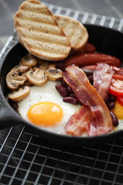 Food and cuisine, English breakfast in frying pan: eggs, bacon, mushrooms, tomatoes, beans and bread