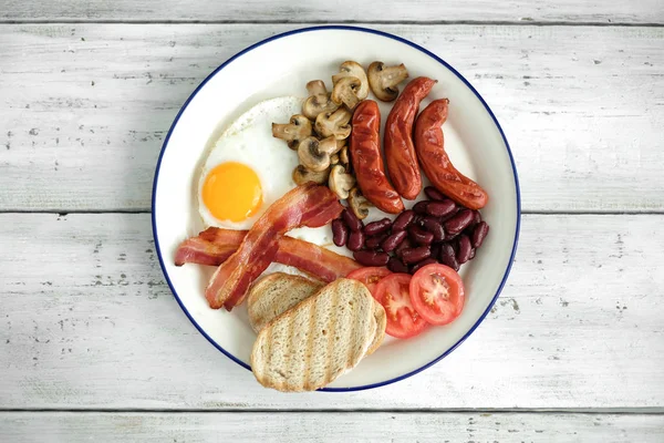 Food and cuisine, English breakfast in white plate: egg, bacon, sausages, mushrooms, tomatoes, beans and bread