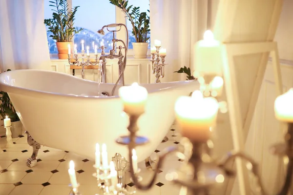 romantic bathroom interior with candles and bathtub