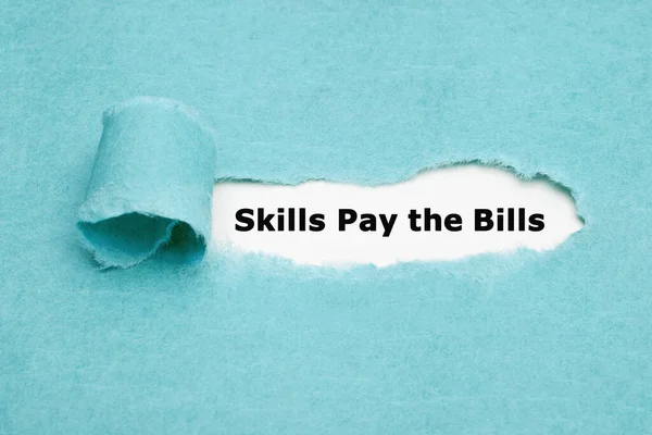 Skills Pay Bills Appearing Torn Blue Paper — стоковое фото
