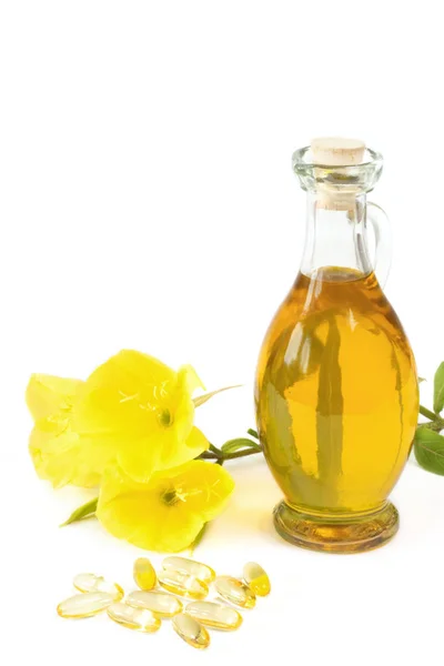 Evening primrose oil with capsules — Stok fotoğraf