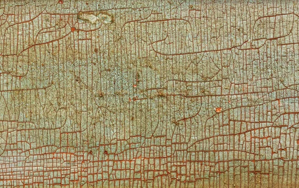 木板裂缝中的旧油漆的背景 — 图库照片