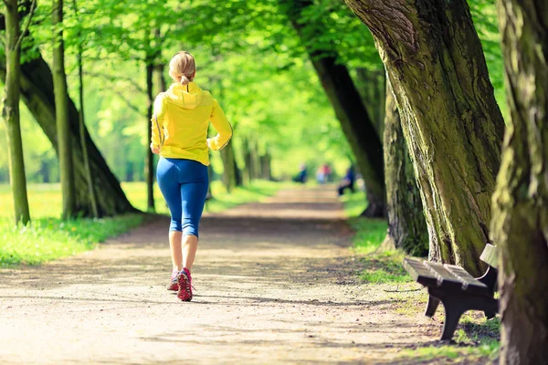 Woman runner running jogging in green summer park and woods — Stock Photo, Image