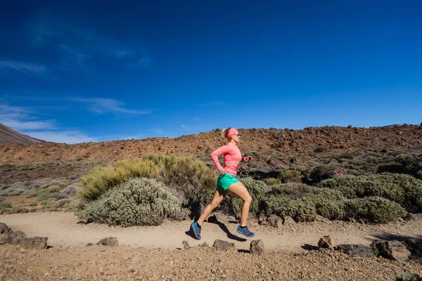 Trail running woman in mountains on sunny day — Stock Photo, Image