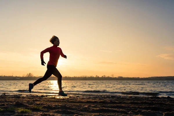 Woman beach running silhouette sunrise, lake coastline — Stock Photo, Image