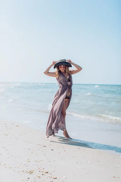 Mujer en la arena en la orilla del mar —  Fotos de Stock