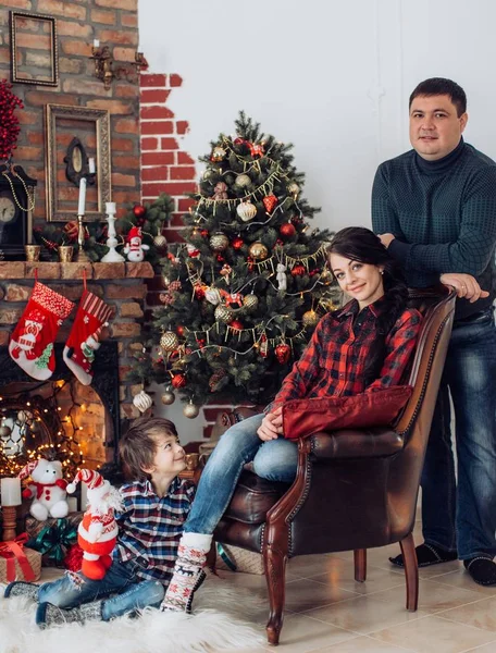 family  at home with decorated Christmas interier