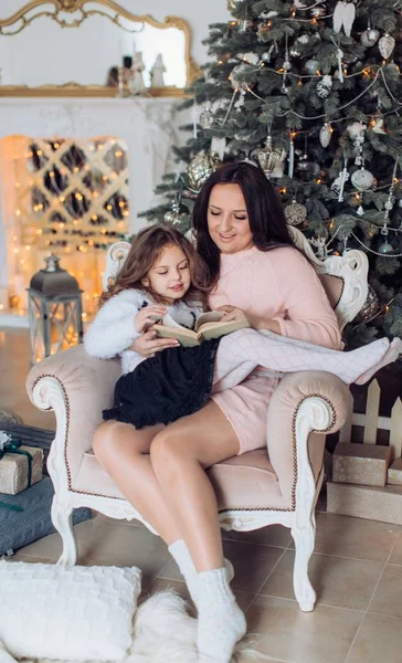 Chica y madre cerca del árbol de Navidad — Foto de Stock