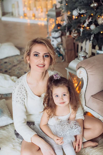 Girl  and mother near Christmas tree Royalty Free Stock Images