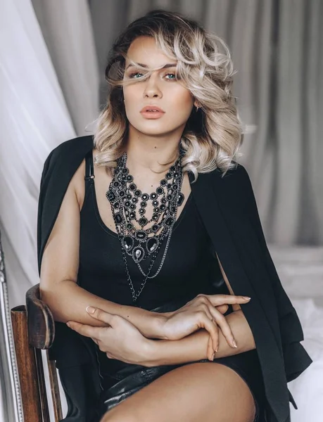 Young blond woman in black dress — Stock Photo, Image