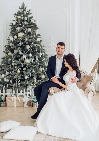 Bride and groom near Christmas tree — Stock Photo, Image