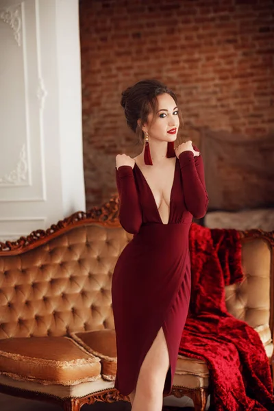 Bella giovane donna in abito bordeaux — Foto Stock