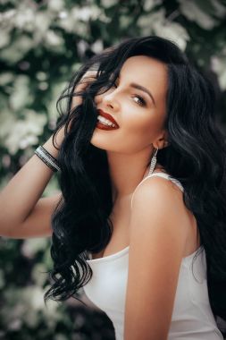 Genç kadın beyaz elbisenin içinde poz 