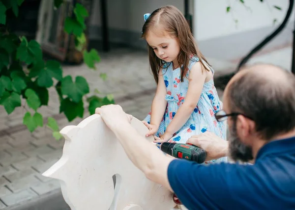 Cute Little Happy Girl Wooden Horse Her Grandfather — Stock Photo, Image