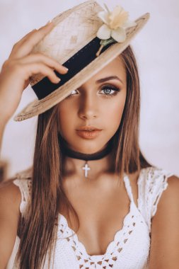 Gerdanlık ve hasır şapka poz olan güzel kadın 