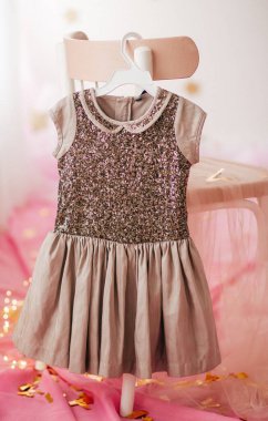 Elbise askısında çocuk elbisesi. Bir kızın ilk doğum günü için giyin.