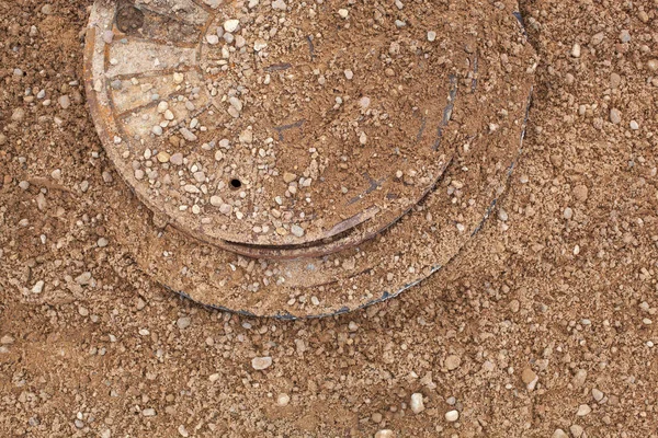 The collector hatch is sprinkled with sand. — Stock Photo, Image