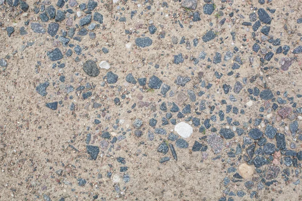 Tratto di strada primo piano di terra, sabbia e pietre granitiche — Foto Stock