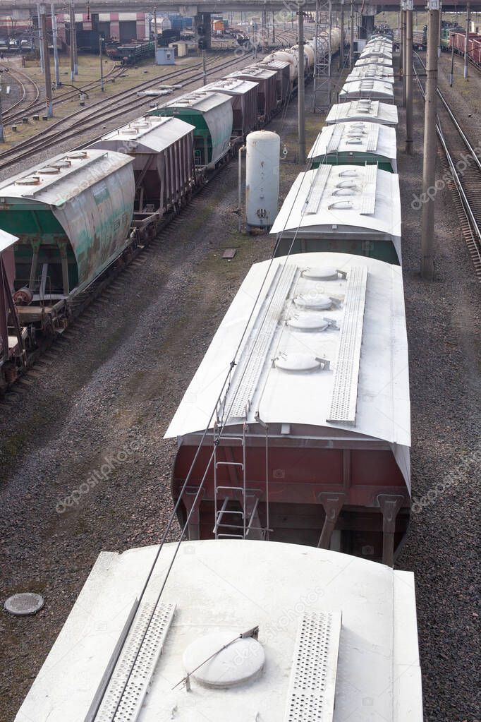 a freight train standing on the tracks waiting to be unloaded or loaded