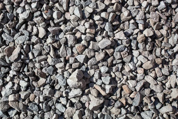 Una gran parte de la roca de grava que es la preparación para el sitio de trabajo de la construcción, material para la construcción industrial. Contexto — Foto de Stock