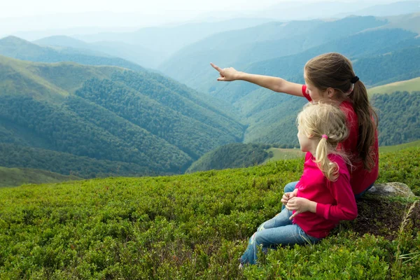 Dvě dívky při pohledu na horách — Stock fotografie