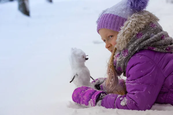 Girl and snowman — Stock Photo, Image