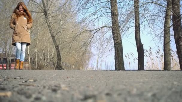 Joven chica caminando al aire libre en el soleado día de primavera — Vídeos de Stock