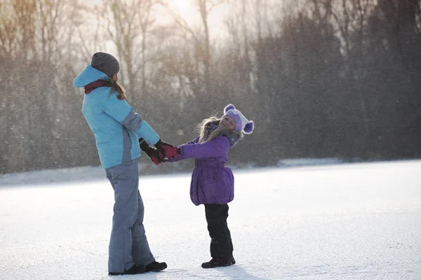 Mother with smiling daughter at the winter  walk — Stock Photo, Image