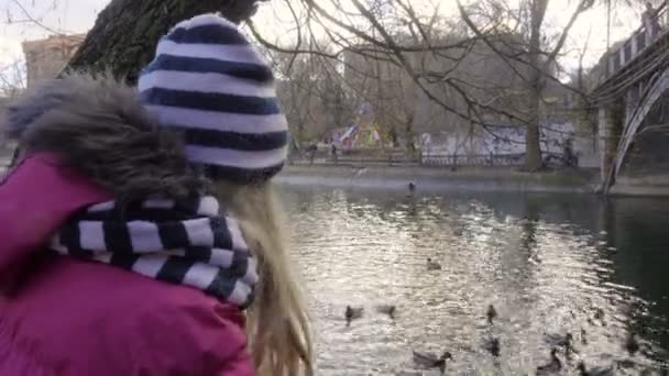 Niños alimentando patos en el parque de otoño — Vídeos de Stock