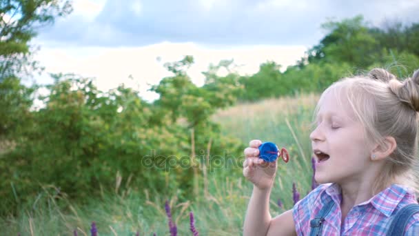Little Girl Blowing Soap Bubbles Green Lawn — Stock Video