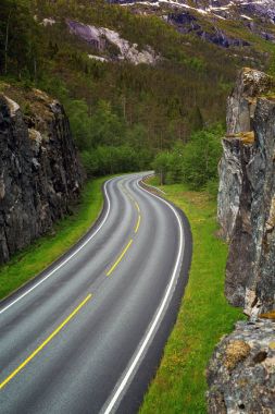 windy road  at the norwegian mountains clipart